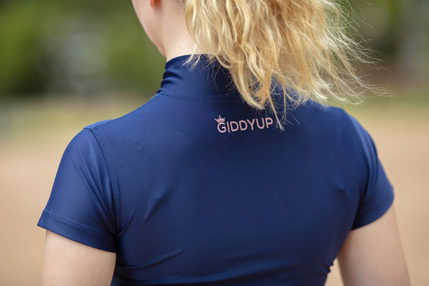 This image shows the back of a navy horse riding top with the word GIDDYUP in a paler colour.